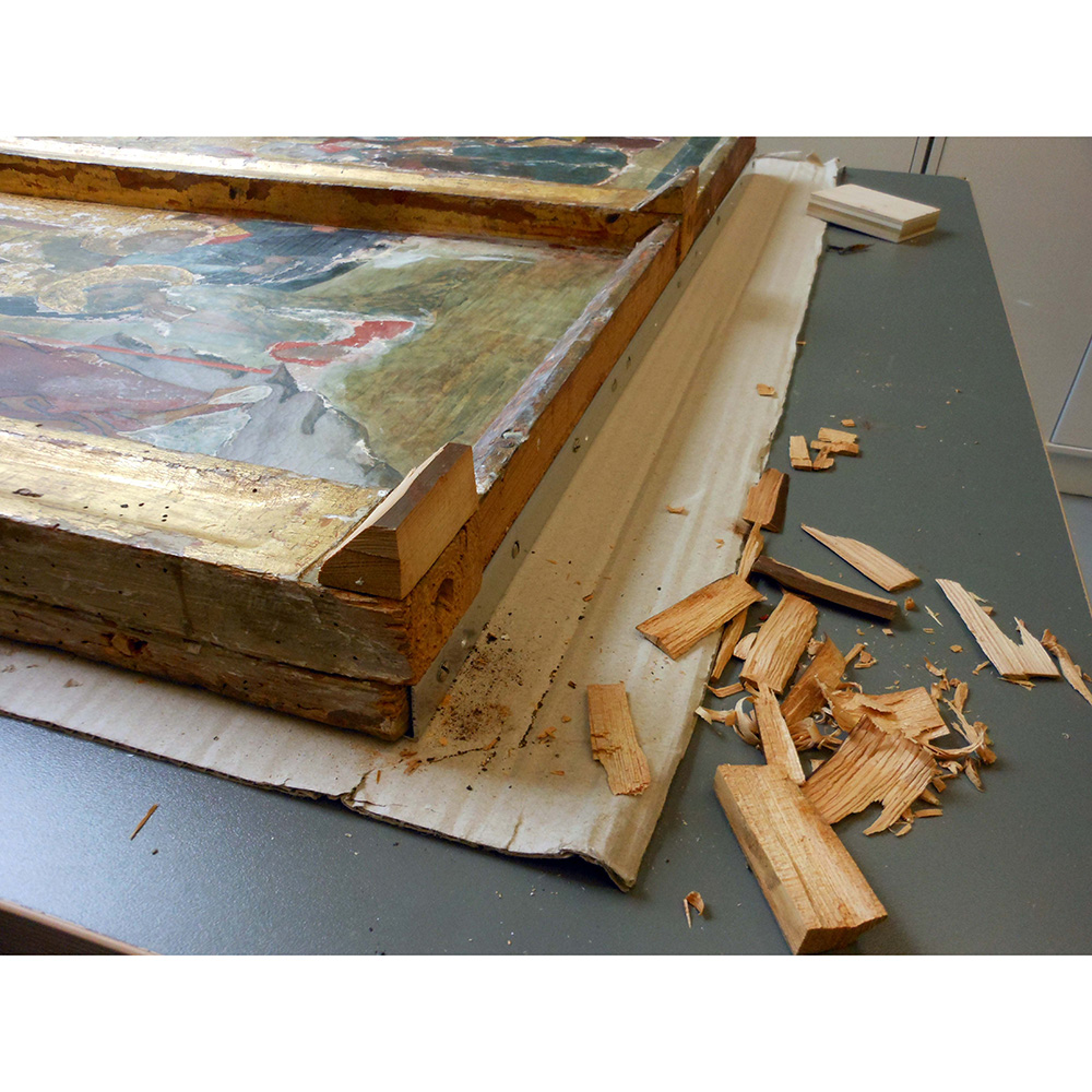 Painting conservation with a crumbling wooden frame