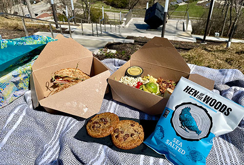 A Picnic in the Park meal featuring sandwich, chips and cookies on the Art Climb