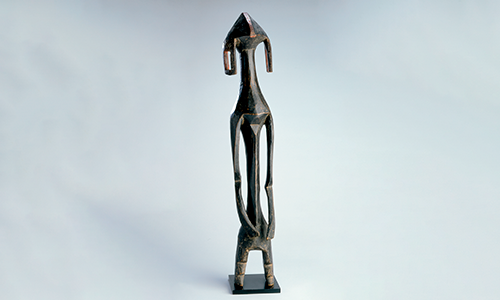 wooden statue of a tall and thin human figure
