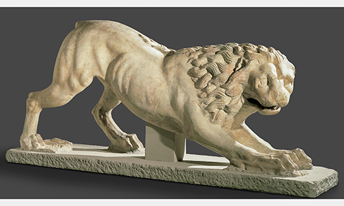 A smooth lion sculpture stretching its front paws.