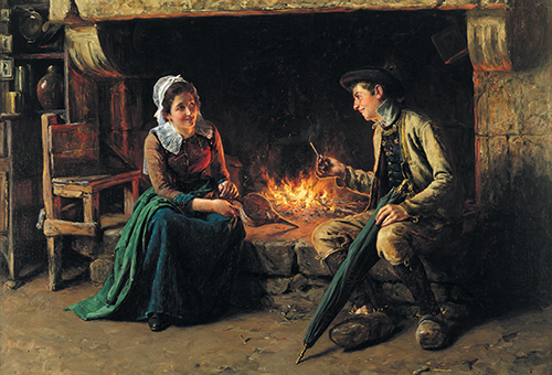 Two young white people sit by the fire