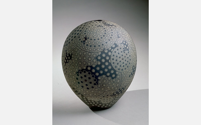 An ovular sculpture with a dotted, circular design