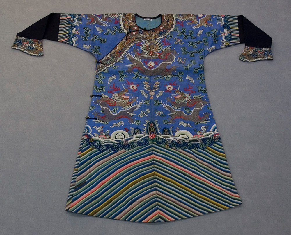 A blue robe with a dragon around the collar and multicolored stripes at the bottom