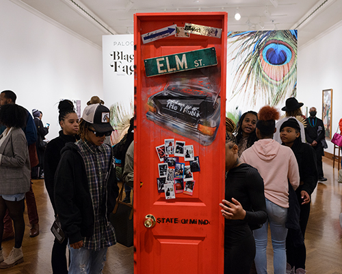 Many Black visitors explore a gallery