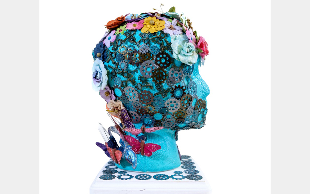 A blue head covered with small gears and colorful flowers.
