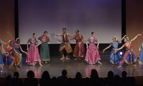 Performers dancing across the stage