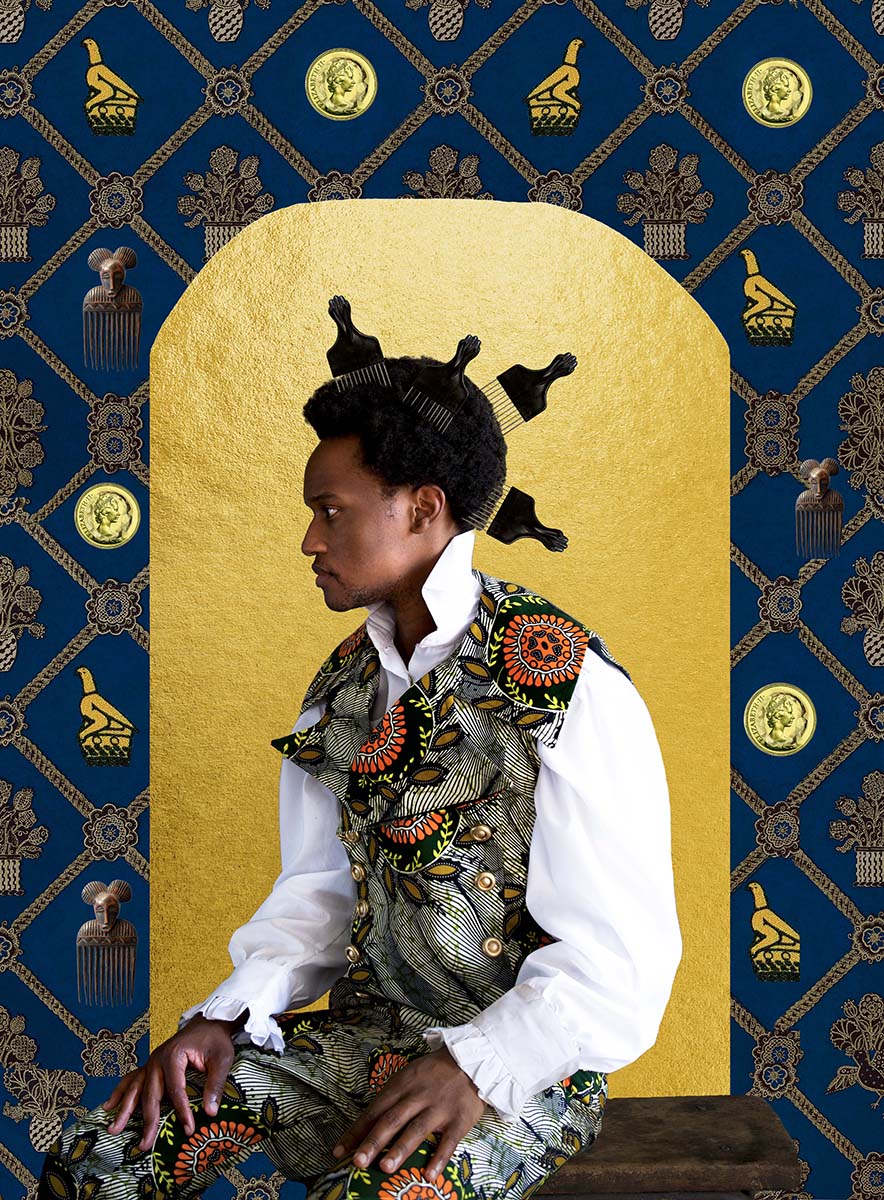 A Black man with four black fro picks in front of an ornate golden background
