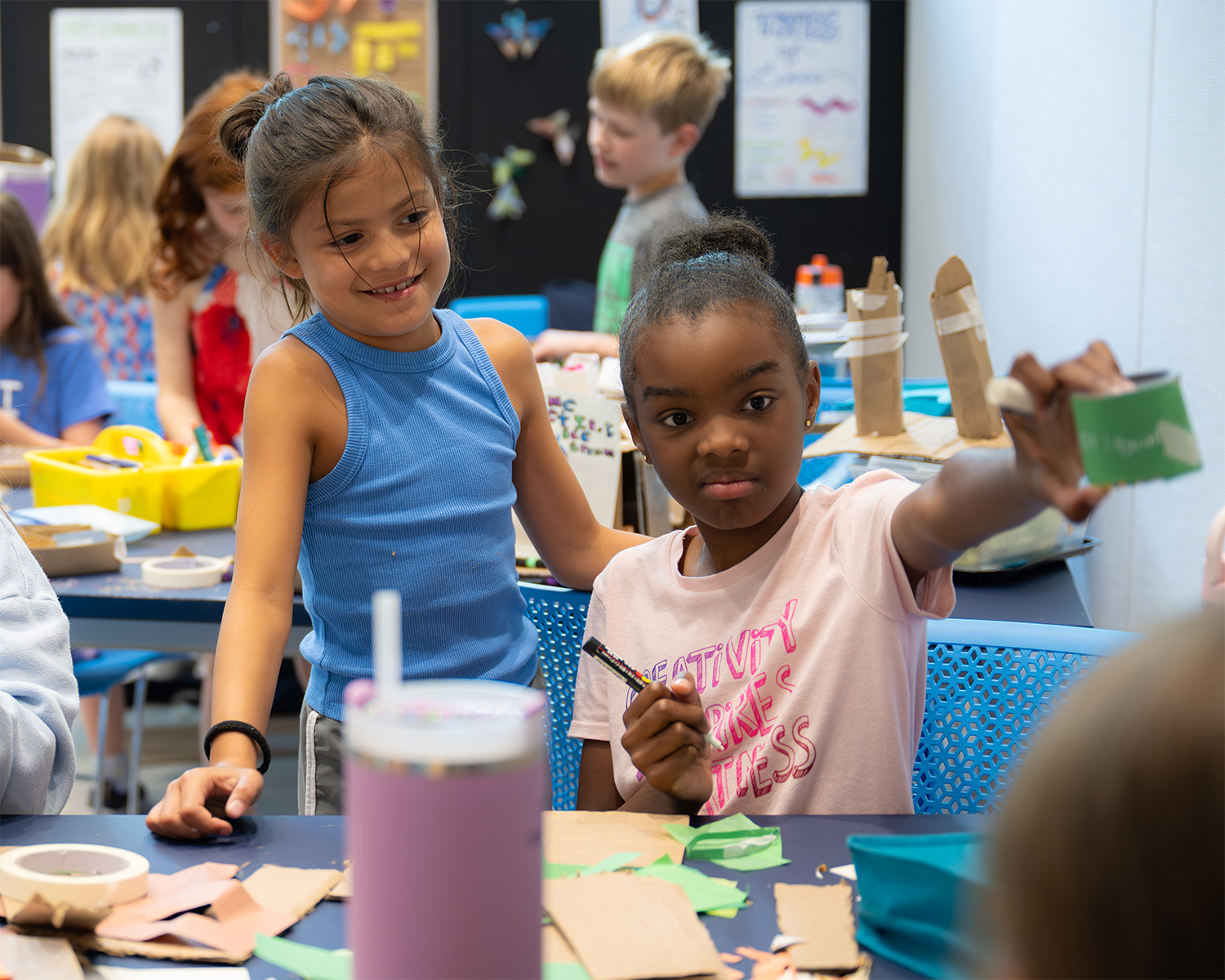 Two young kids make art together