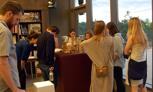 Visitors inspect various works in the Mary R. Schiff library
