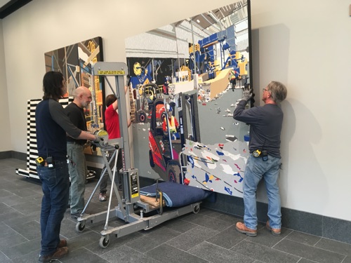 installation crew hanging a painting