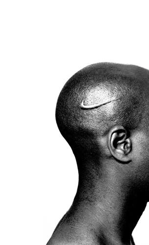 Black and white photo of the head of an African American man with the Nike swoosh logo