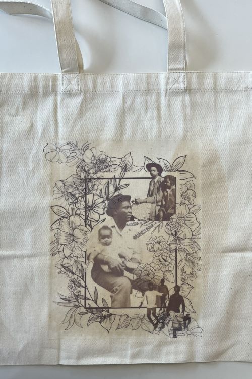 Cloth carrying bag with photographic images of people and illustrated designs of plants.
