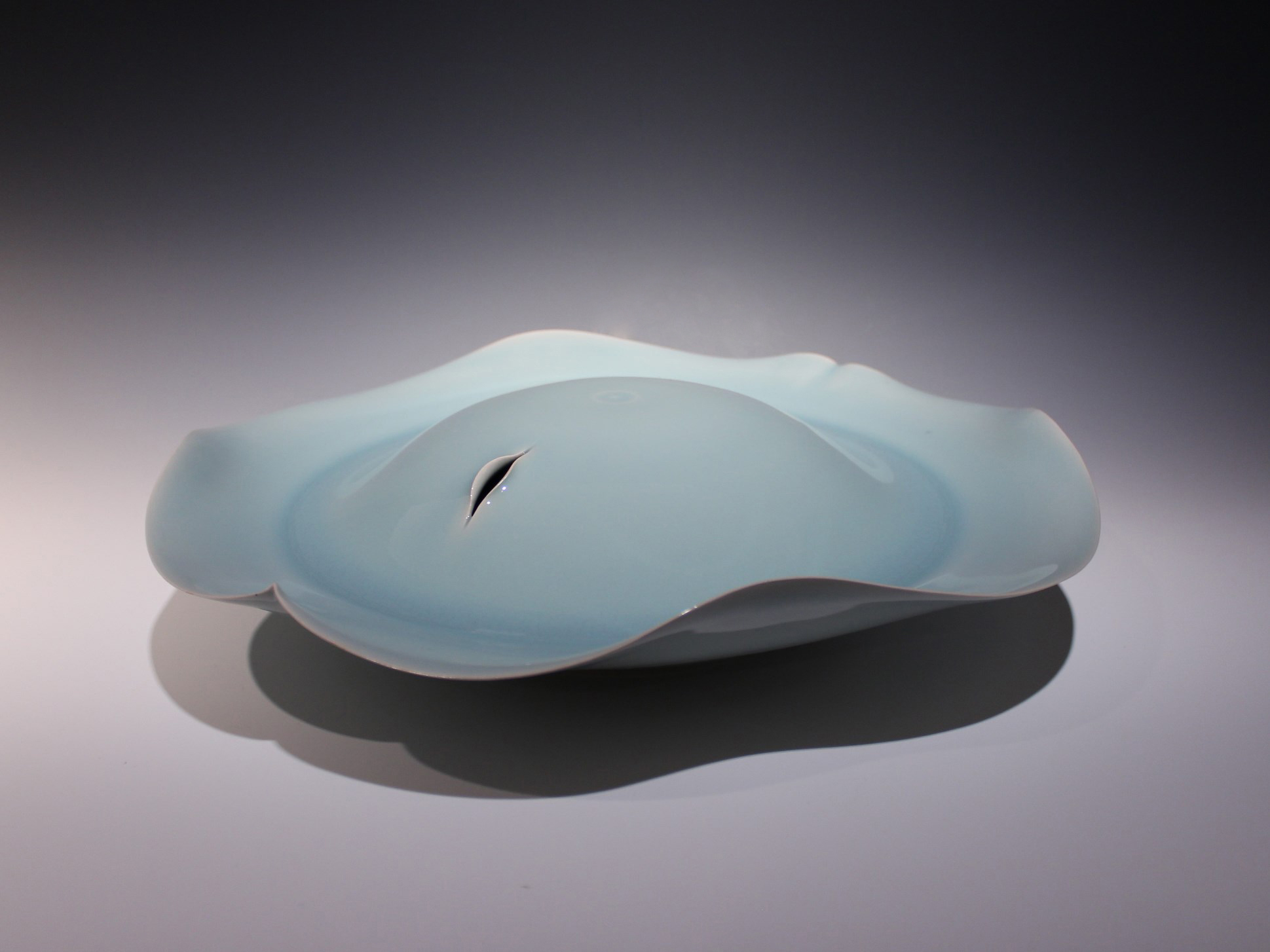 Kawase Shinobu's Jar, a flattened, light blue porcelain jar, with flowing edges and a small slit for an opening