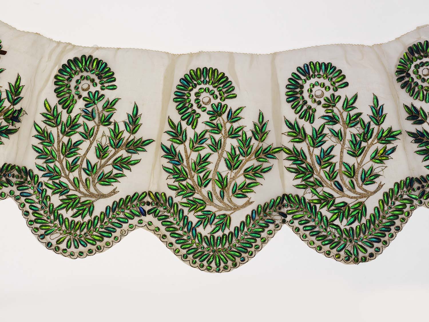 dress with a pattern of decorative green leafed tree branches 