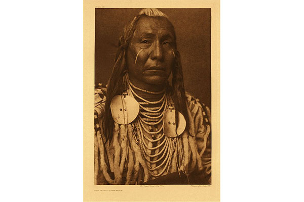 a sepia toned photograph of a Native American man