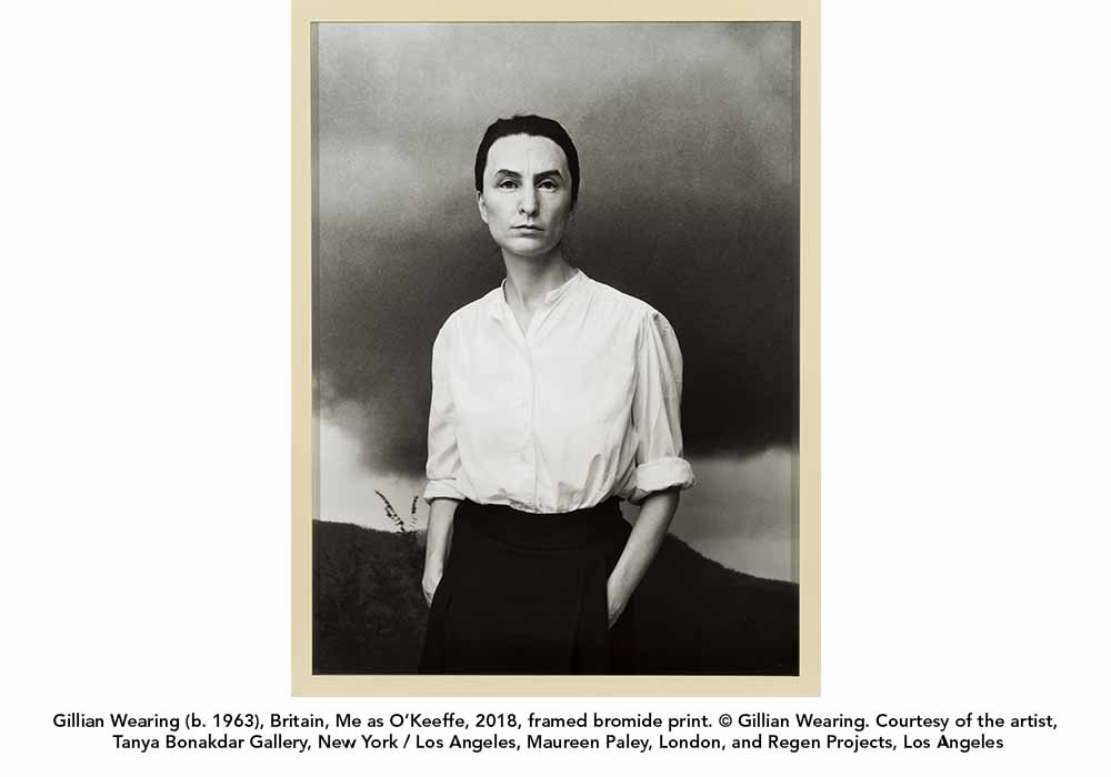 A black and white photograph of Gillian Wearing disguised as Georgia O'Keeffe