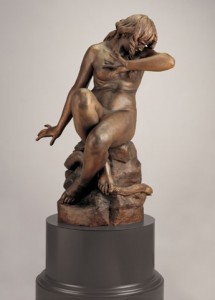 bronze statue of Eve sitting on a rock turing her body away