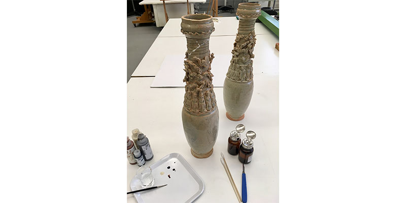 two thin jars in conservation
