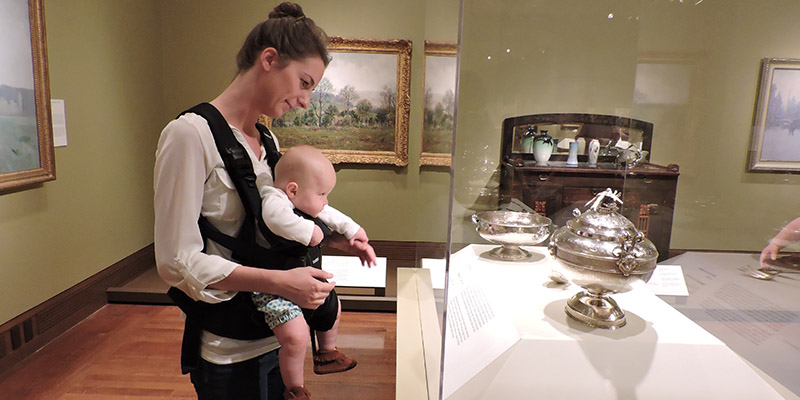 mother and baby inspecting artwork