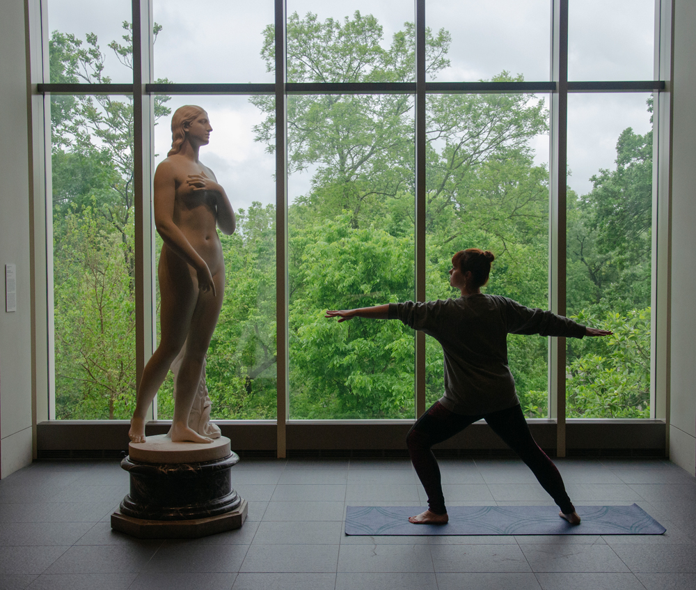 A woman practicing yoga in an exhibition