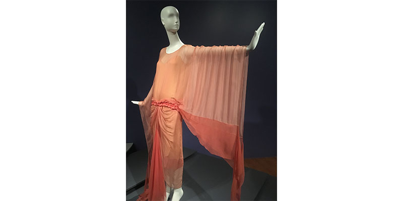 peach colored dress with long, draping sleeves