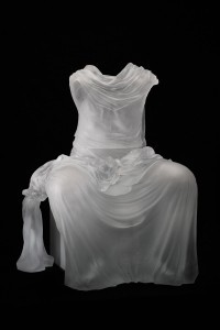glass sculpture of a dress in a seated position despite the absence of any wearer