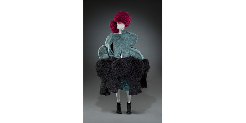 Rei Kawakubo's Dress, Belt, Shoes, and Socks. A gray-blue, large dress with an asymmetrical shape. A large, thick, black fur skirt hangs at the waist