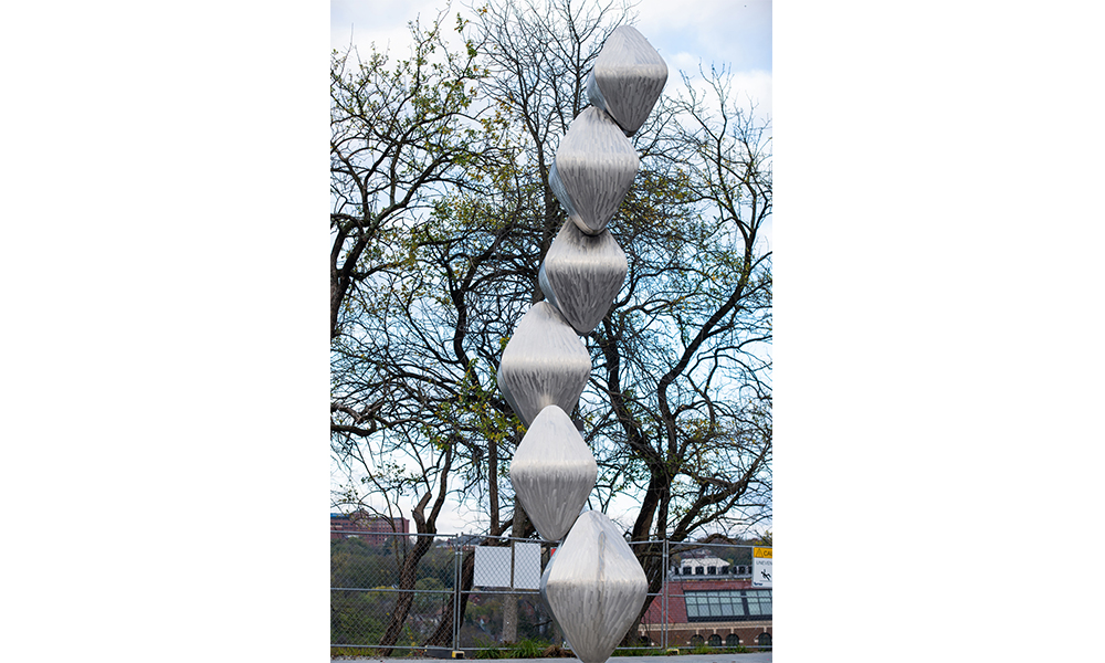 Barton Rubenstein's Skybound, a tall statue of brushed metal diamonds stacked atop each other in a spiral pattern