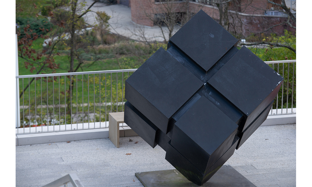 Tony Rosenthal's Cube, a black cube made up of smaller cubes standing on one of its corners