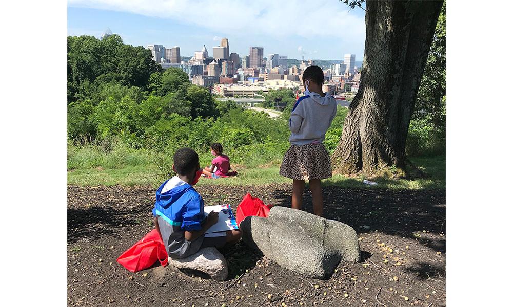 A group of campers admiring the Cincinnati skyline