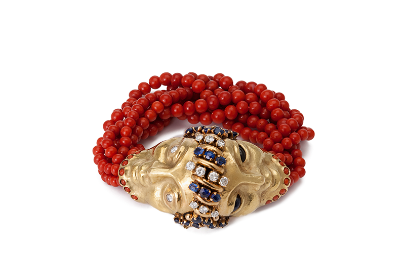Franco Cannilla and Mario Masenza's Janus Head Bracelet, featuring two gold heads fused at their jeweled hair with red coral beads.
