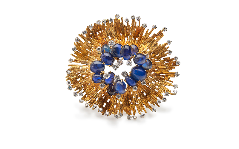 Andrew Grima's, Pendant/Brooch, round with an irregular edge and made of textured, matte gold, plus sapphires, diamonds.