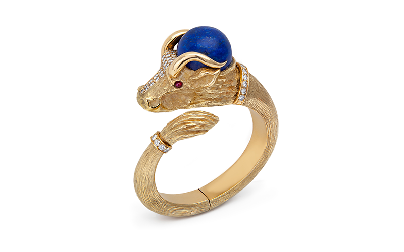 René Morin and Chaumet's Bull Bracelet, a thick, gold open bangle with a bull's head at one end, featuring ruby eyes, a large bead of lapis lazuli on its crown, and a collar of faceted diamonds.
