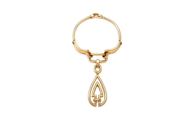 Van Cleef & Arpels' Necklace, a smooth, solid gold necklace with an upward-pointing arrow pendant.