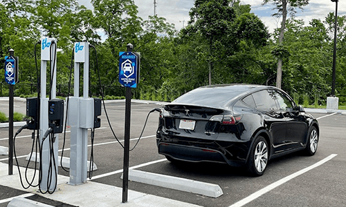 A Tesla charges at CAM's EV Charging Station