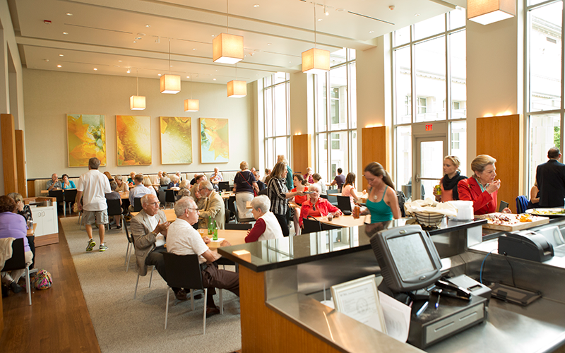 The Terrace Café features many tables and seating with large windows to the courtyard