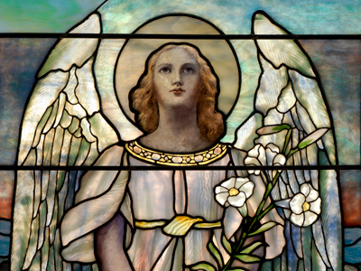 stained glass depicting an angel holding flowers