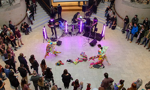 A crowd watches dancers perform in the Great Hall