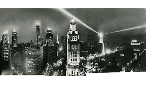 A city filled with the glowing lights of skyscrapers and electric streetlamps