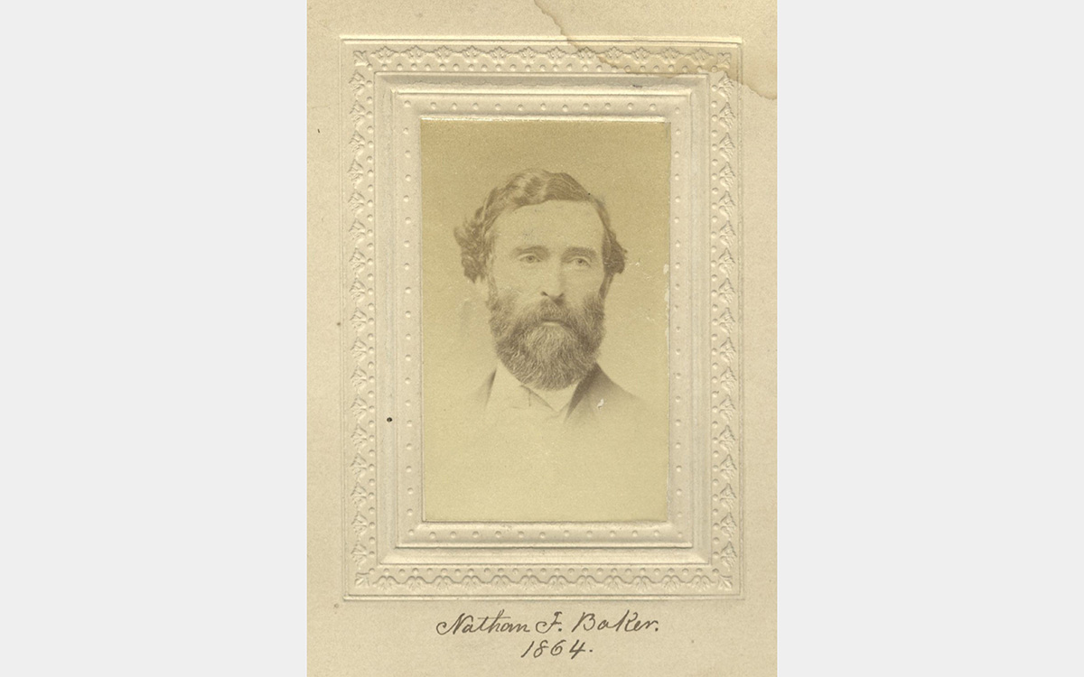 A sepia-colored photographic portrait of a man with a full beard