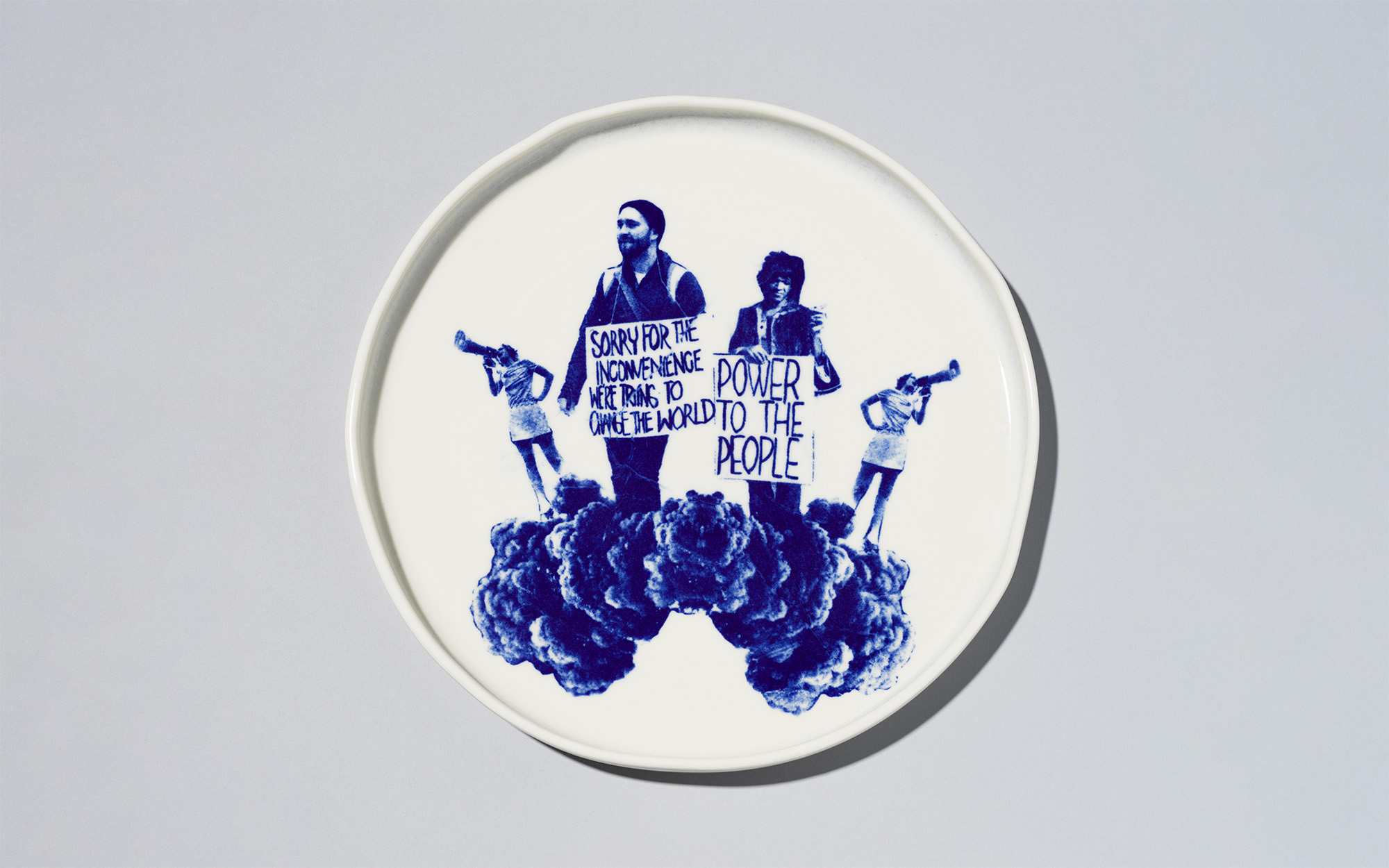 A white plate with blue image of people protesting