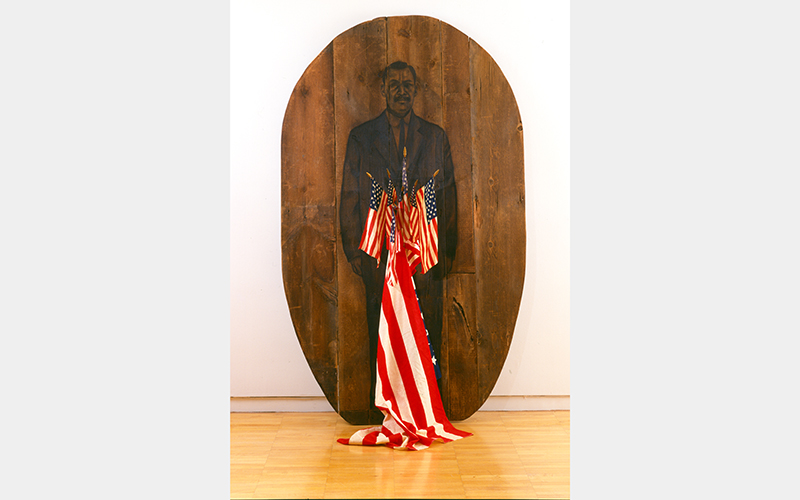 An illustration of a man wearing a suit on dark wood. Several small American flags sit in front, including one large one draped on the floor.