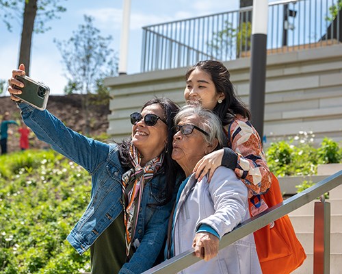 A family poses for a selfie on the Art Climb