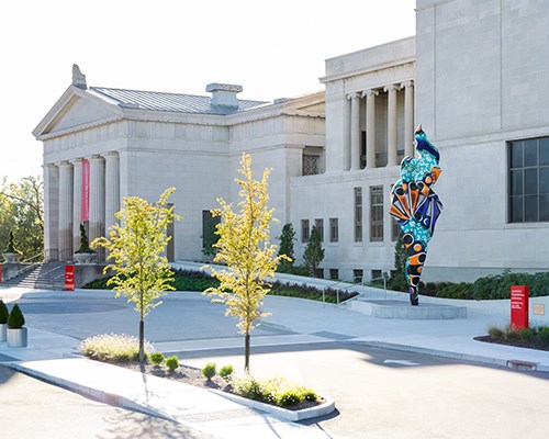 The front entrance of the Museum, featuring a tall colorful sculpture