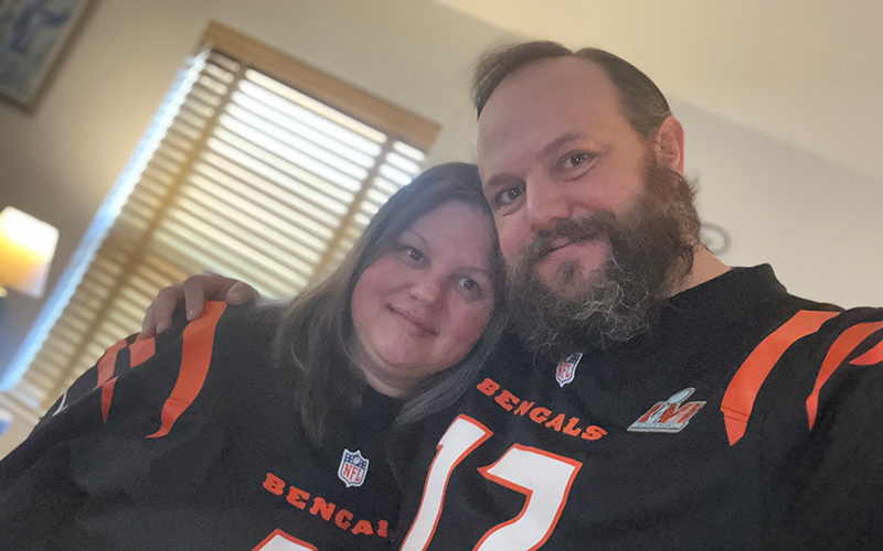 James and Alicia smile in their Bengals jerseys