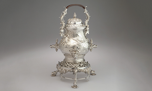 An ornately carved silver urn.