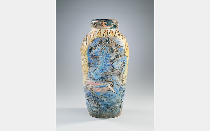 A jar with a blue head that has many eyes 