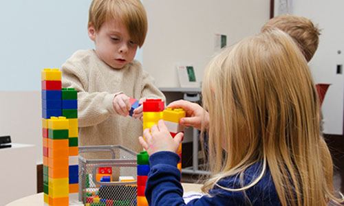 youth visitors playing with building blocks