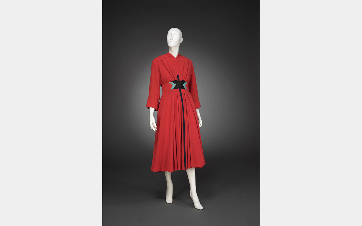White mannequin wearing a red-colored dress