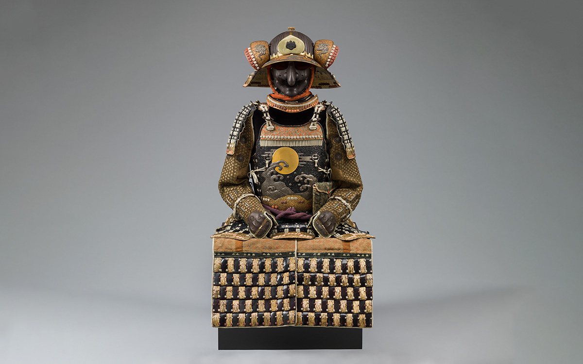 An ornate suit of armor with a sunlit wave design on the chest